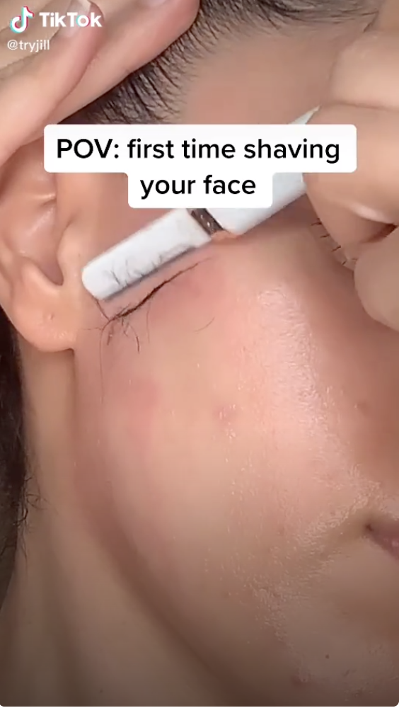 An up-close shot of a person shaving their cheek with the text, &quot;POV: first time shaving your face&quot;
