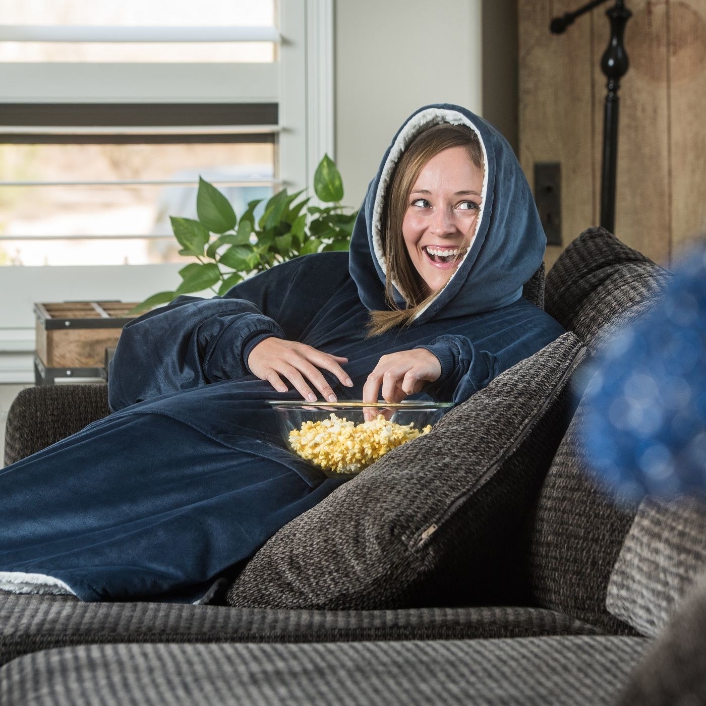 Model wearing blue blanket with popcorn
