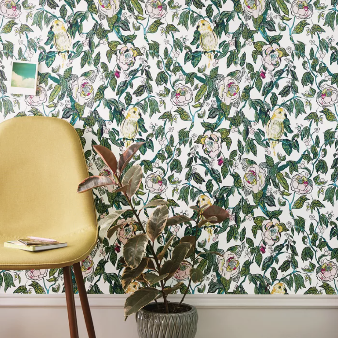 Yellow Canary and pink floral wallpaper behind yellow chair and plant