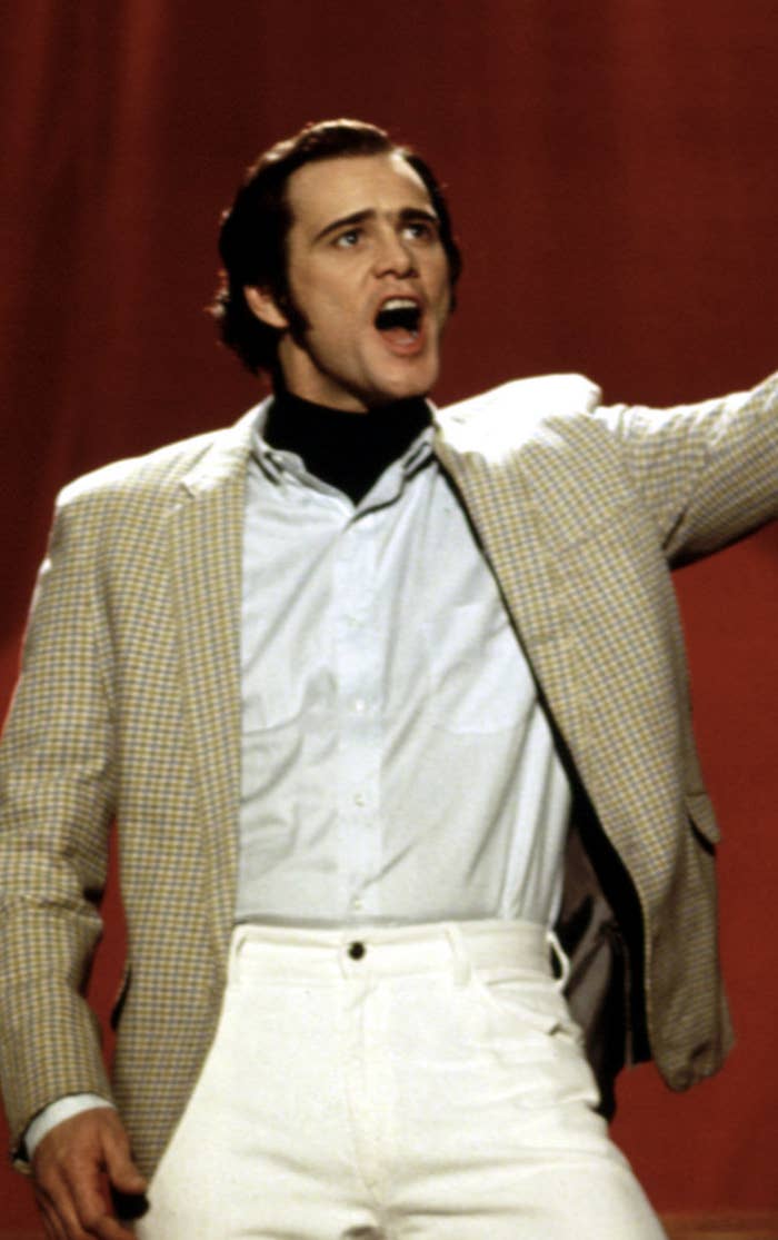 Carrey wearing a blazer, buttoned-down shirt, and turtleneck like Kaufman