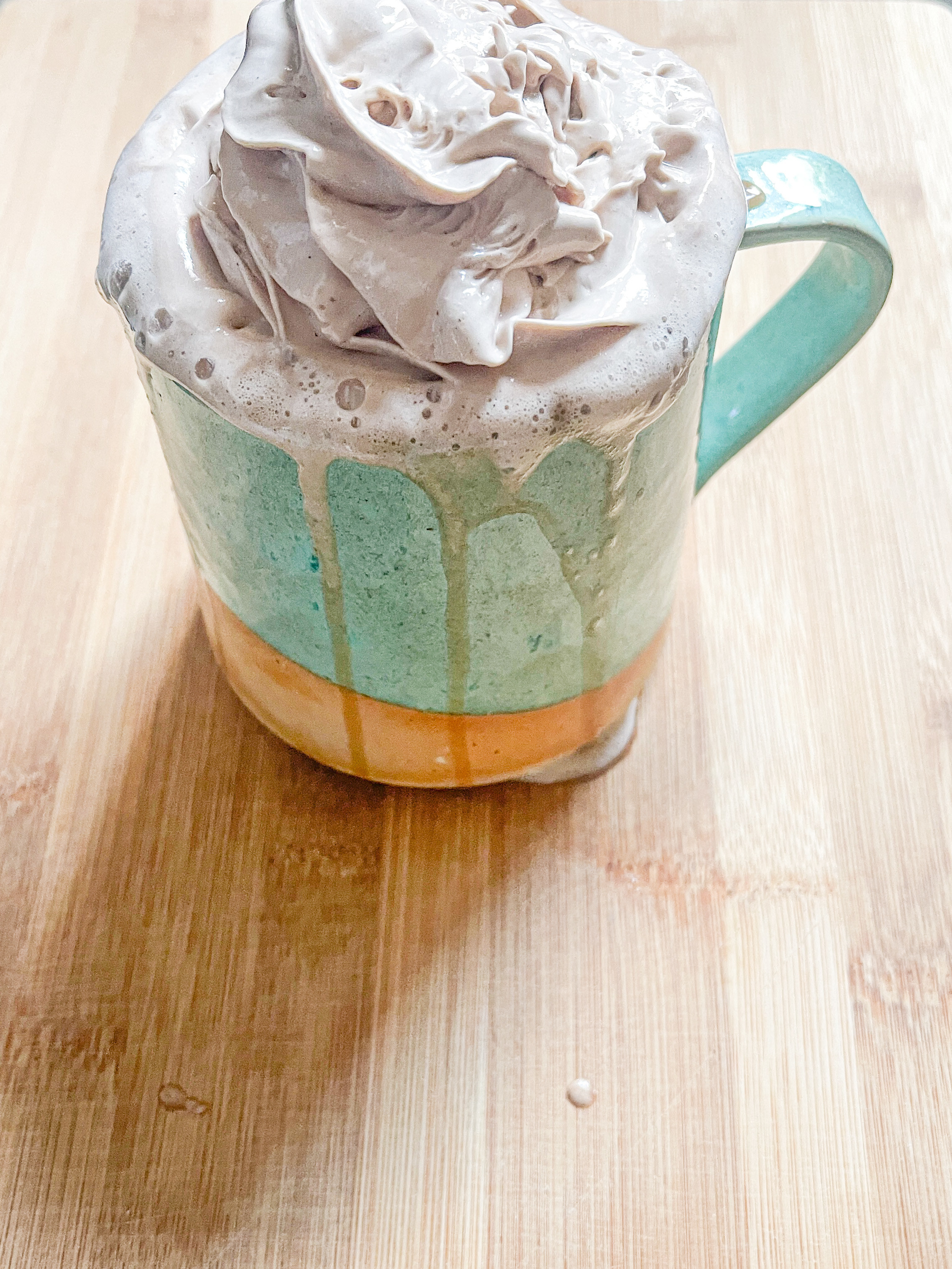 Whipshots overflowing as a topping for coffee in a mug