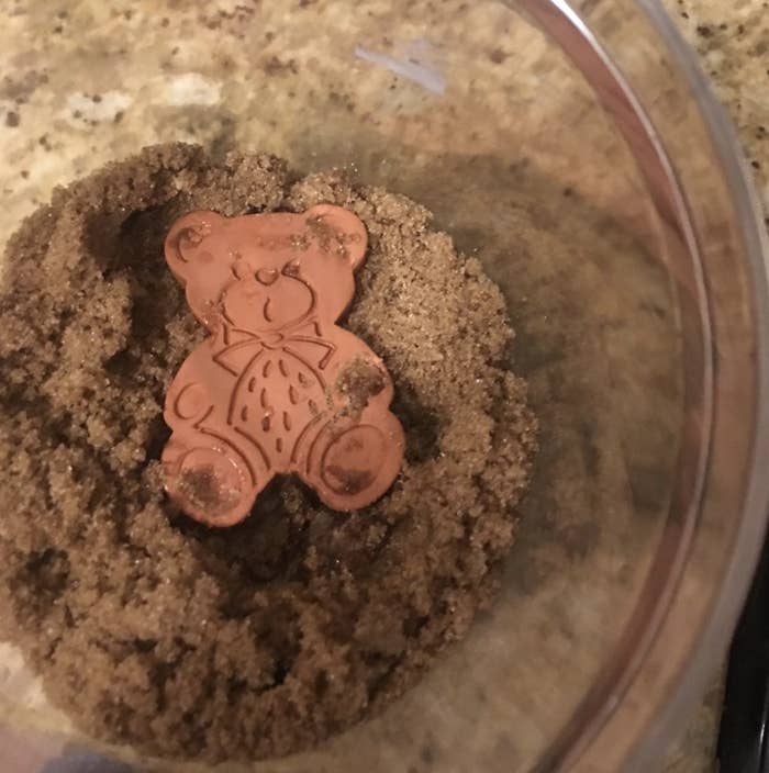 A customer review photo of the brown sugar bear sitting next to a jar of brown sugar