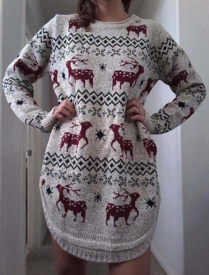 Reviewer wearing Christmas sweater with long hem