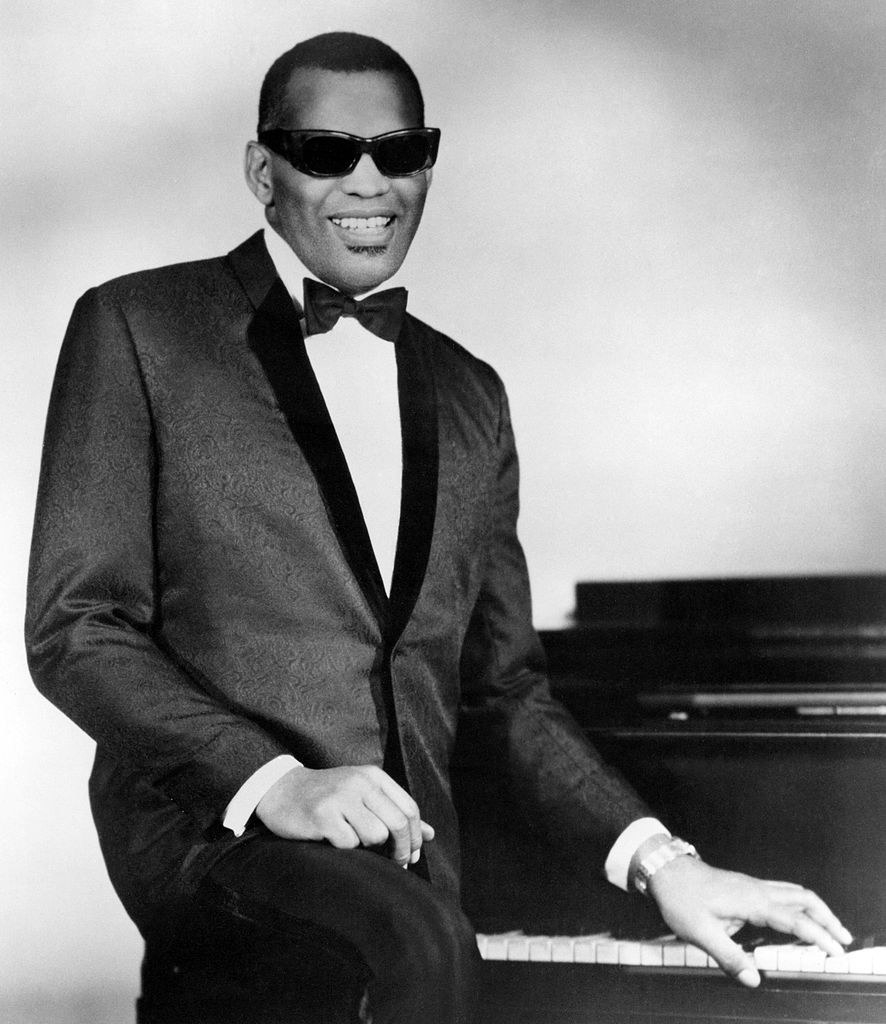 Charles posing for a portrait by his piano, late &#x27;50s/early &#x27;60s