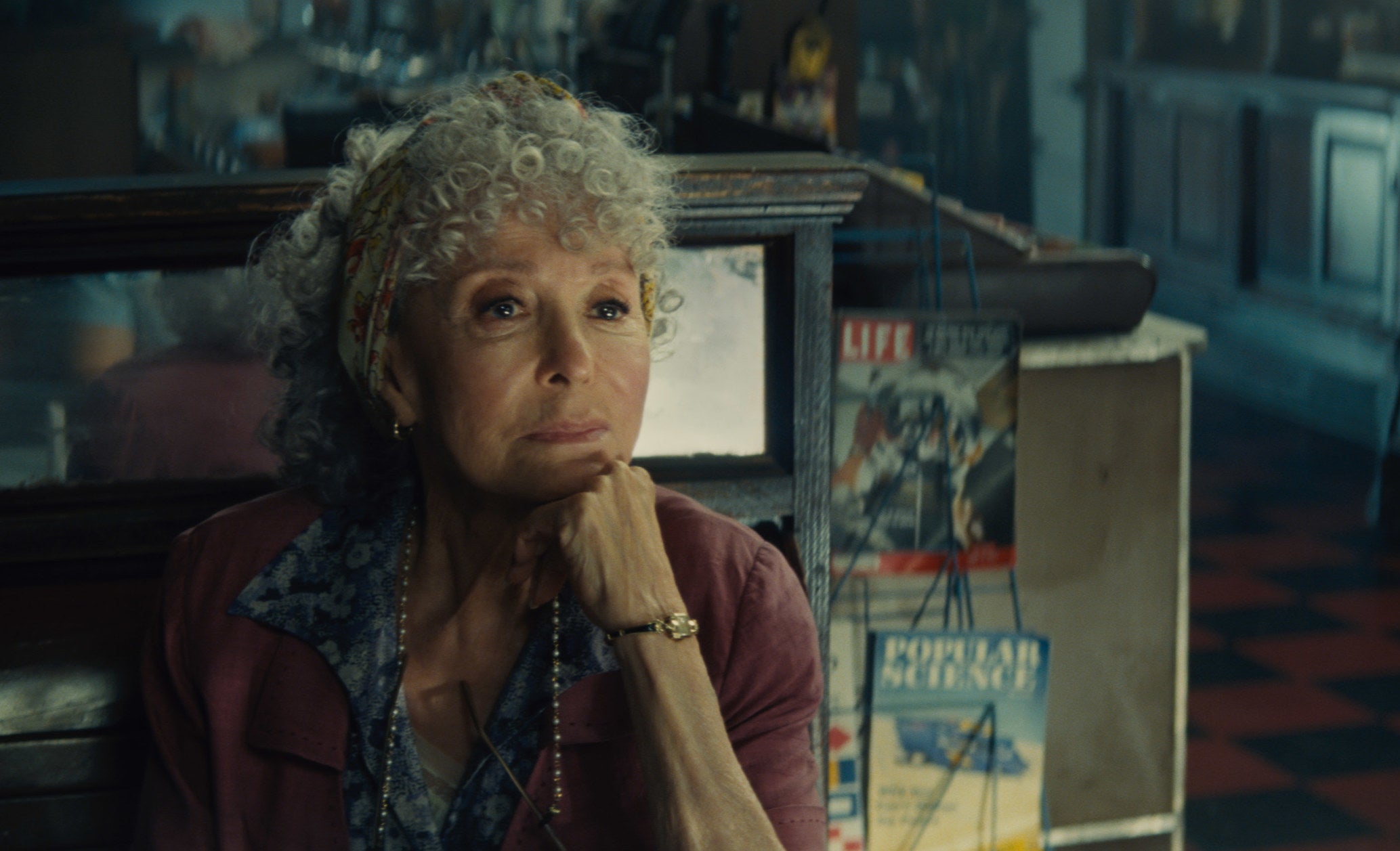 Rita Moreno as Valentina, siting in the drug store, chatting with Tony