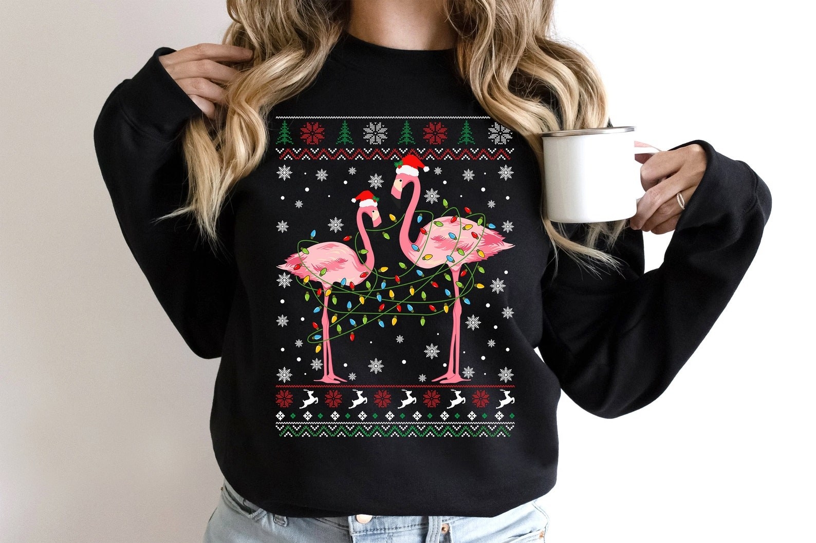 Model wearing Christmas sweater with flamingo pattern