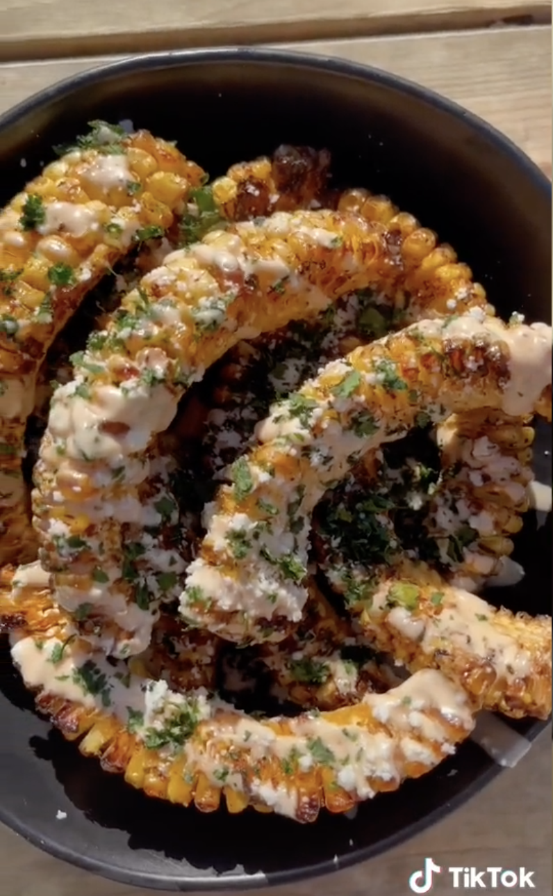 A plate of corn &quot;ribs&quot; topped with cotija cheese and cilantro
