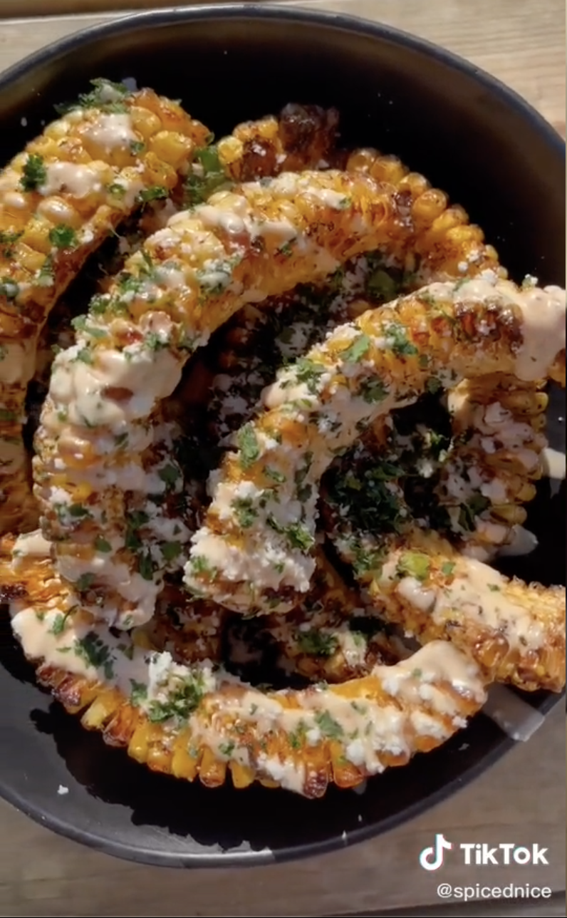 A plate of corn &quot;ribs&quot; topped with cotija cheese and cilantro