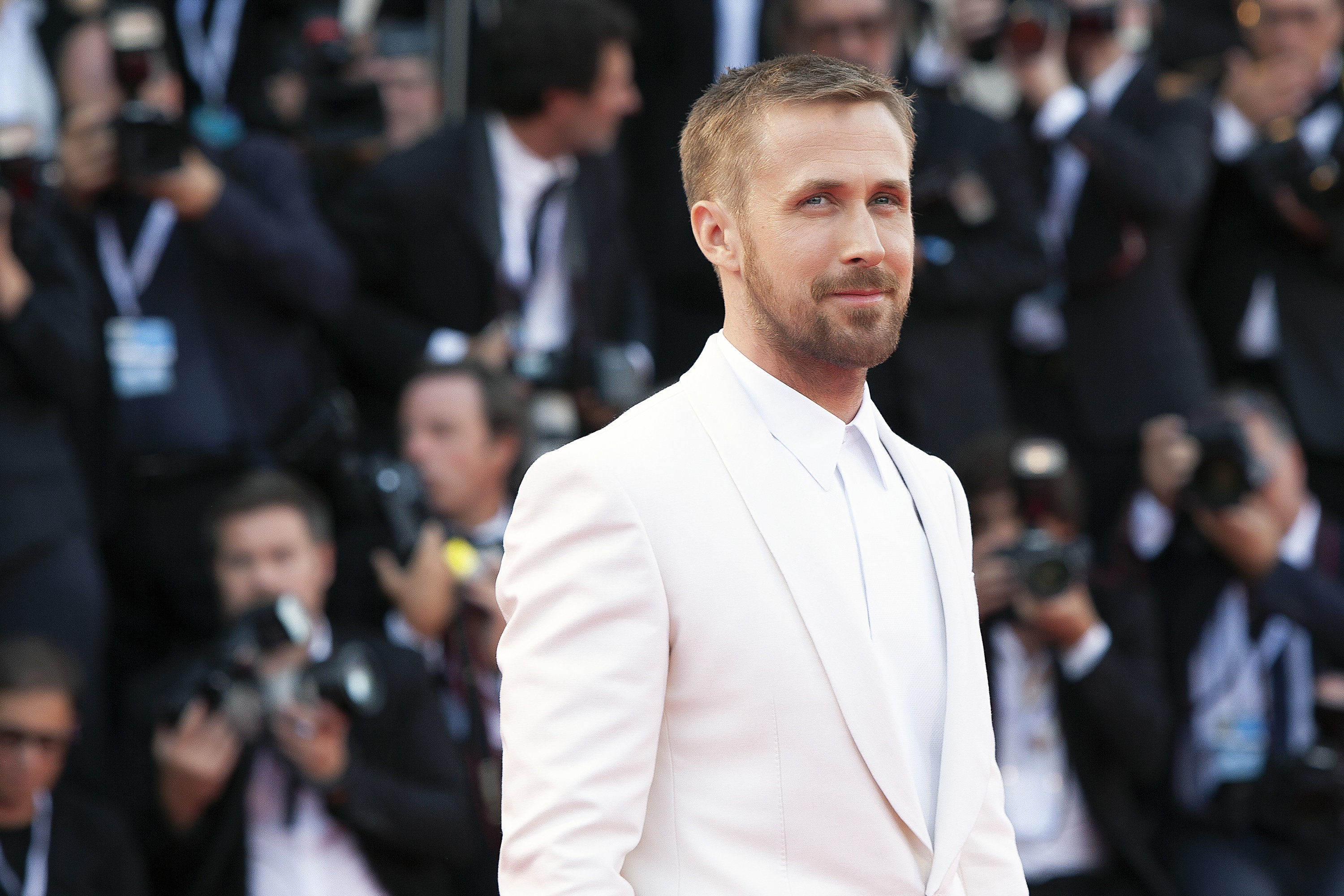 Ryan Gosling smiling for cameras on the red carpet