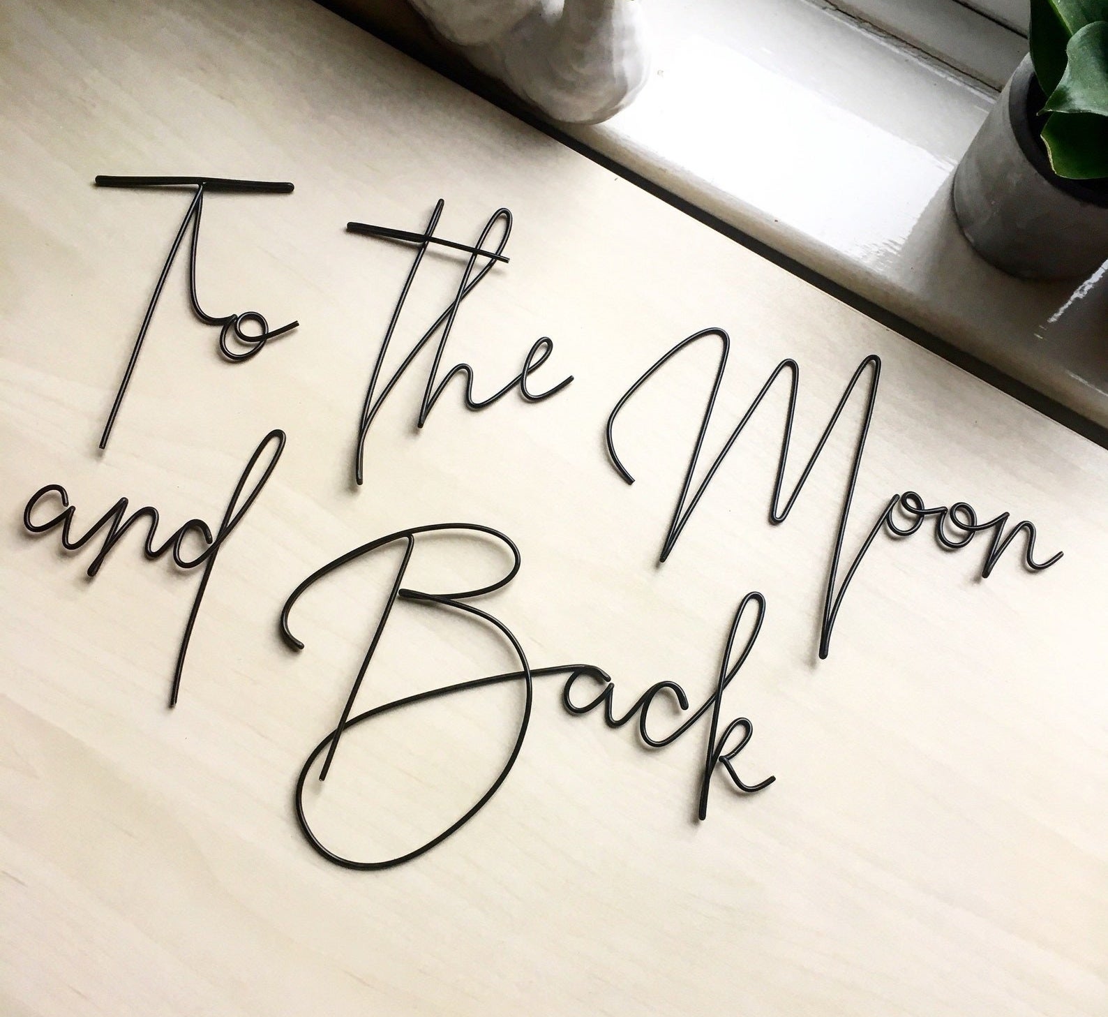 Black &quot;to the moon and back&quot; wire word sign