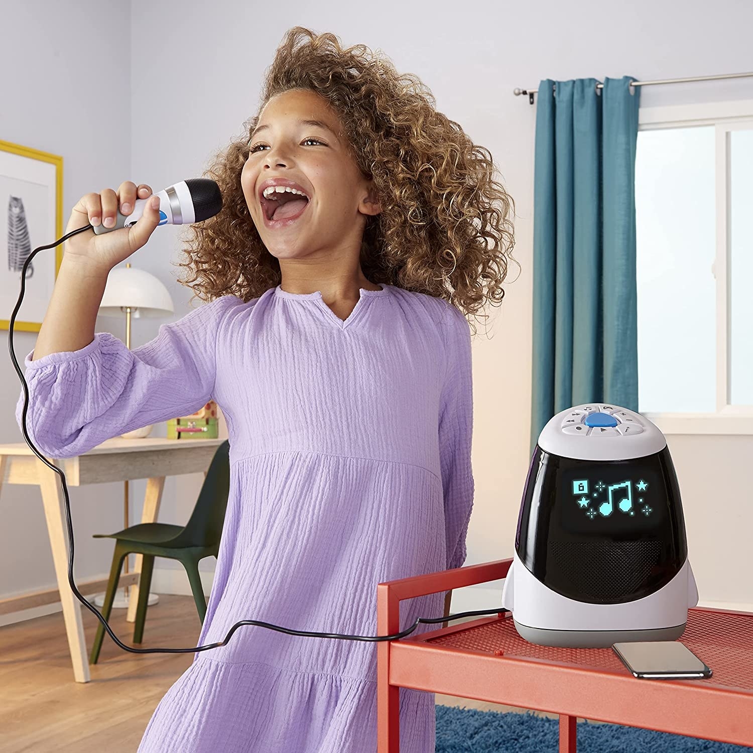 a child singing karaoke with the machine