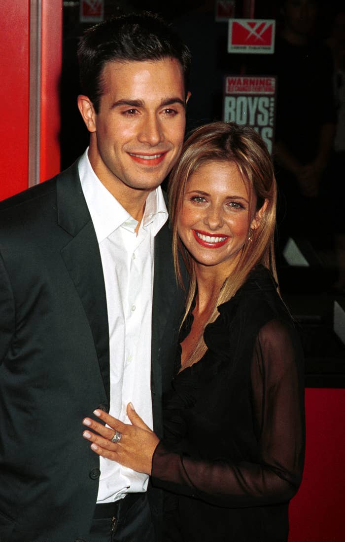 Gellar poses for a photo with Prinze while putting her hand on his stomach at a red carpet event