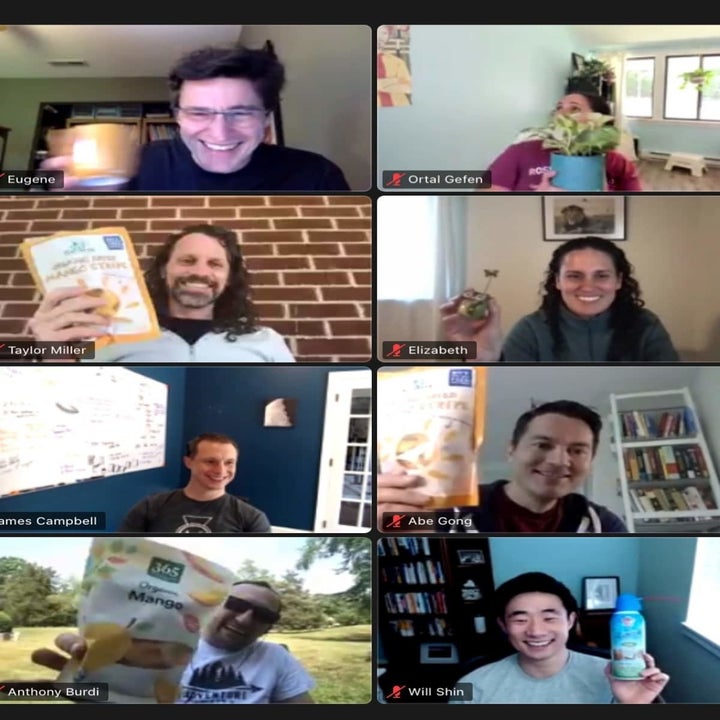 screenshot of a video call with participants each holding a seemingly random item