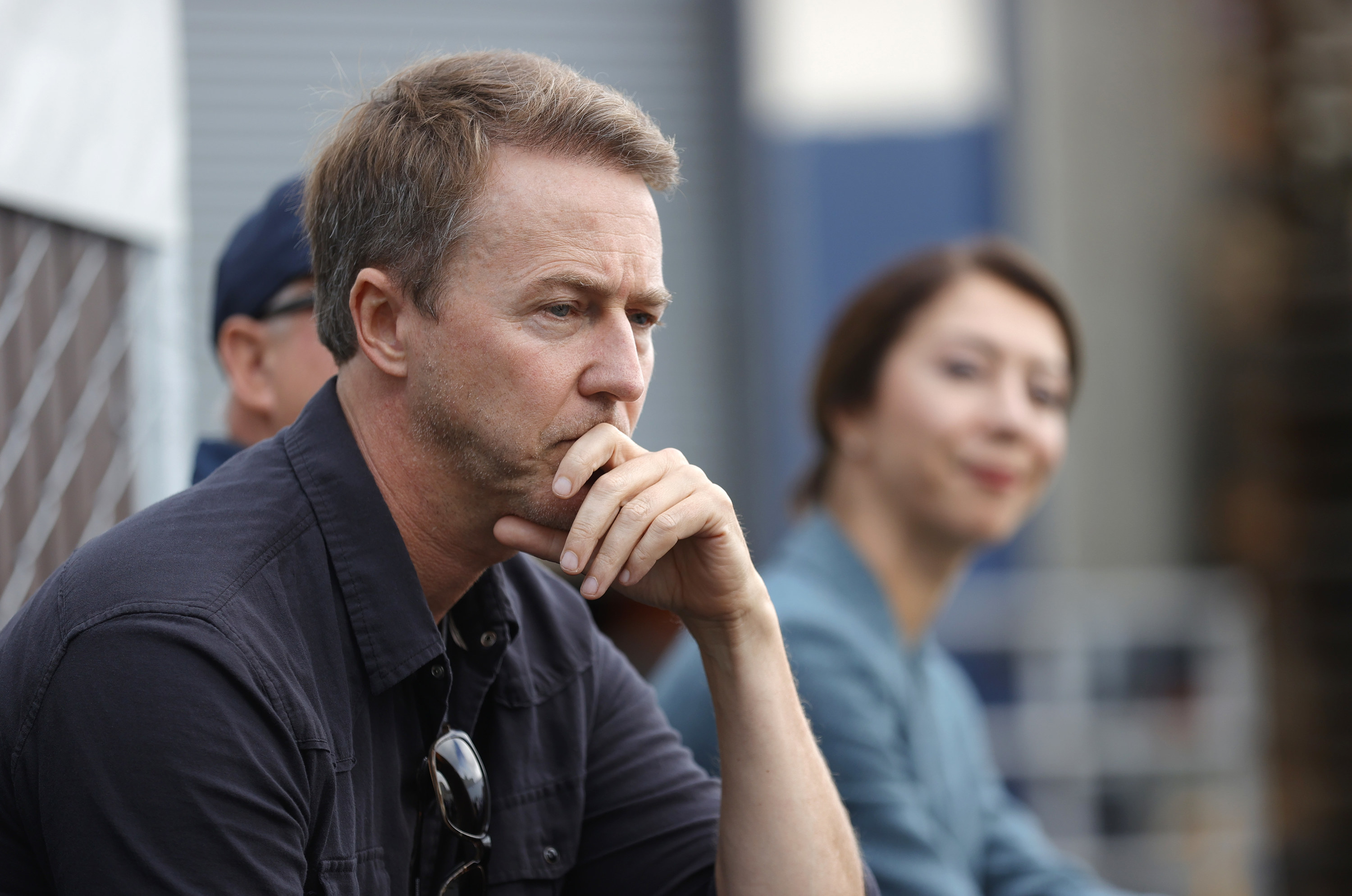 Edward Norton appearing to look pensive while sitting down
