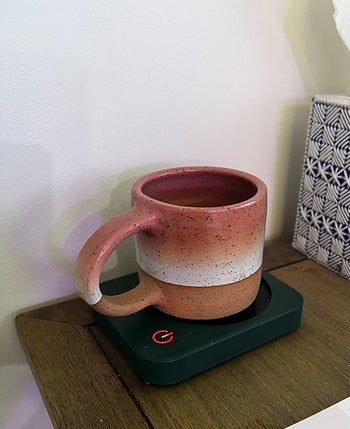 a reviewer using the black mug warmer