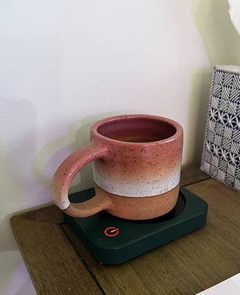 a reviewer's mug on the black warmer