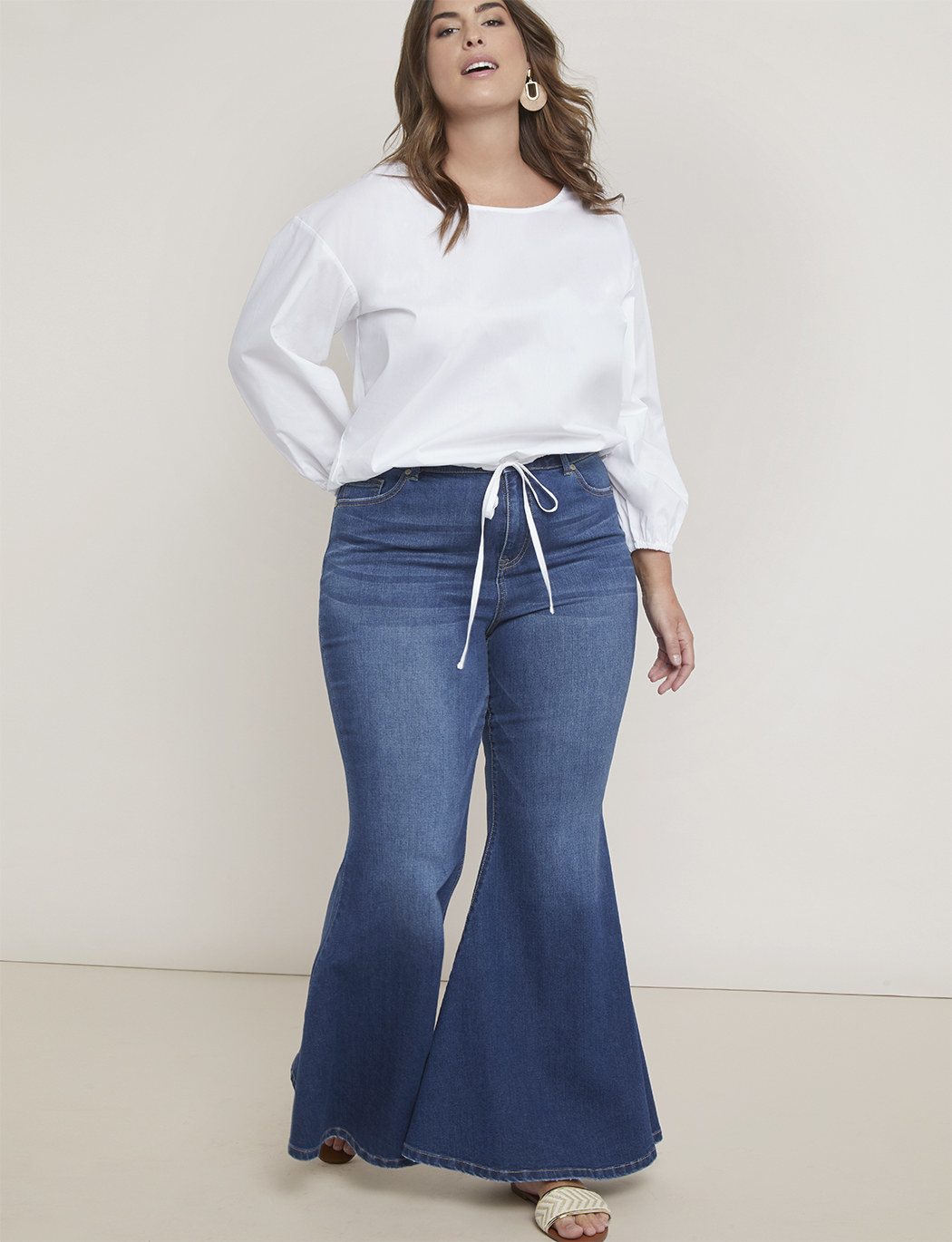 Model wearing light wash flare jeans
