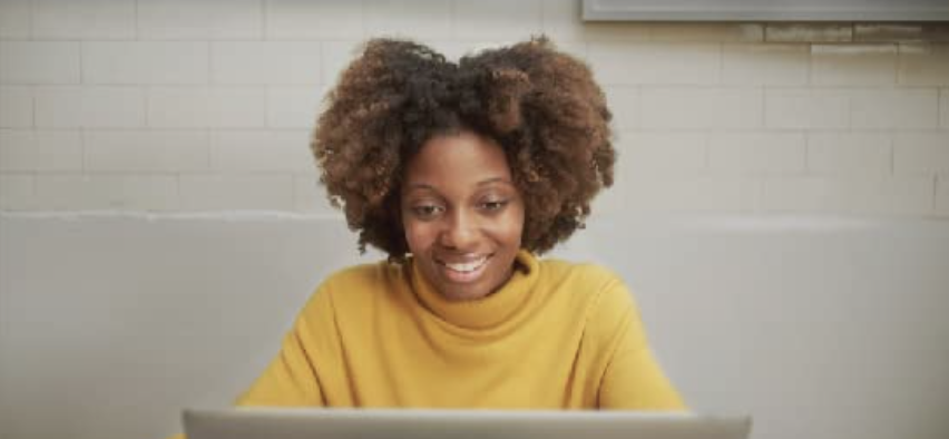 model looking at a laptop screen