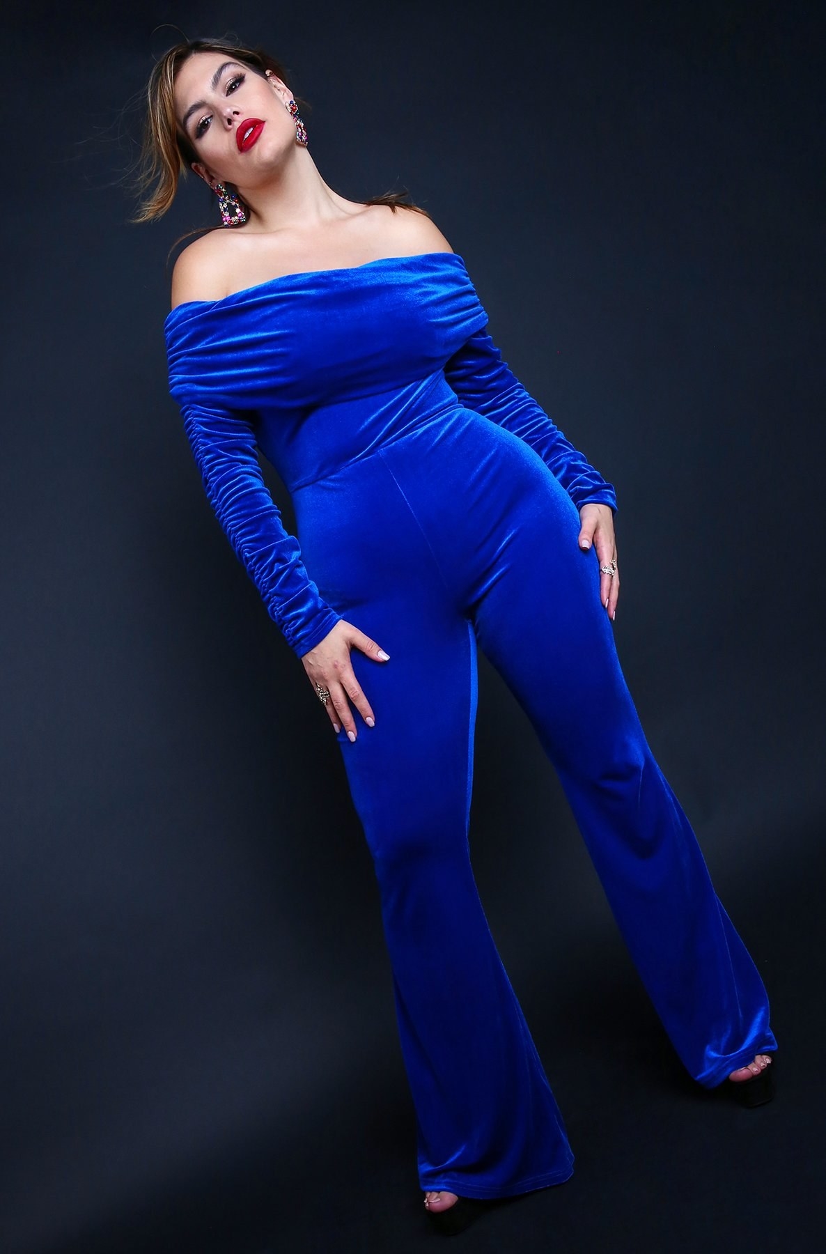 model in royal blue jumpsuit with long ruched sleeves