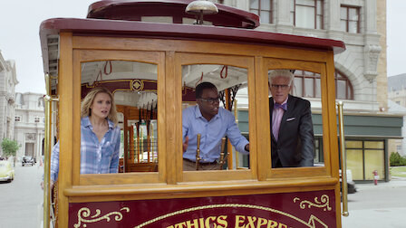Eleanor, Michael and Chidi inside a wooden trolley.