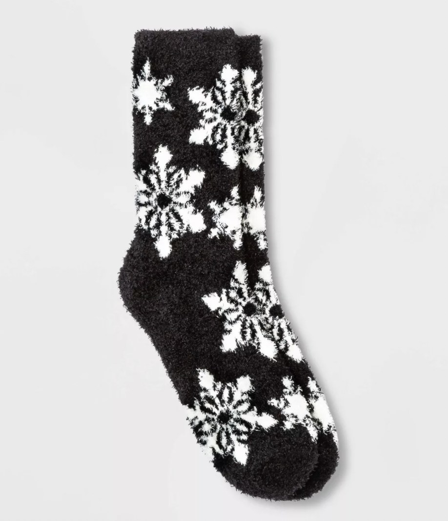 Pair of black crew socks with white snowflakes