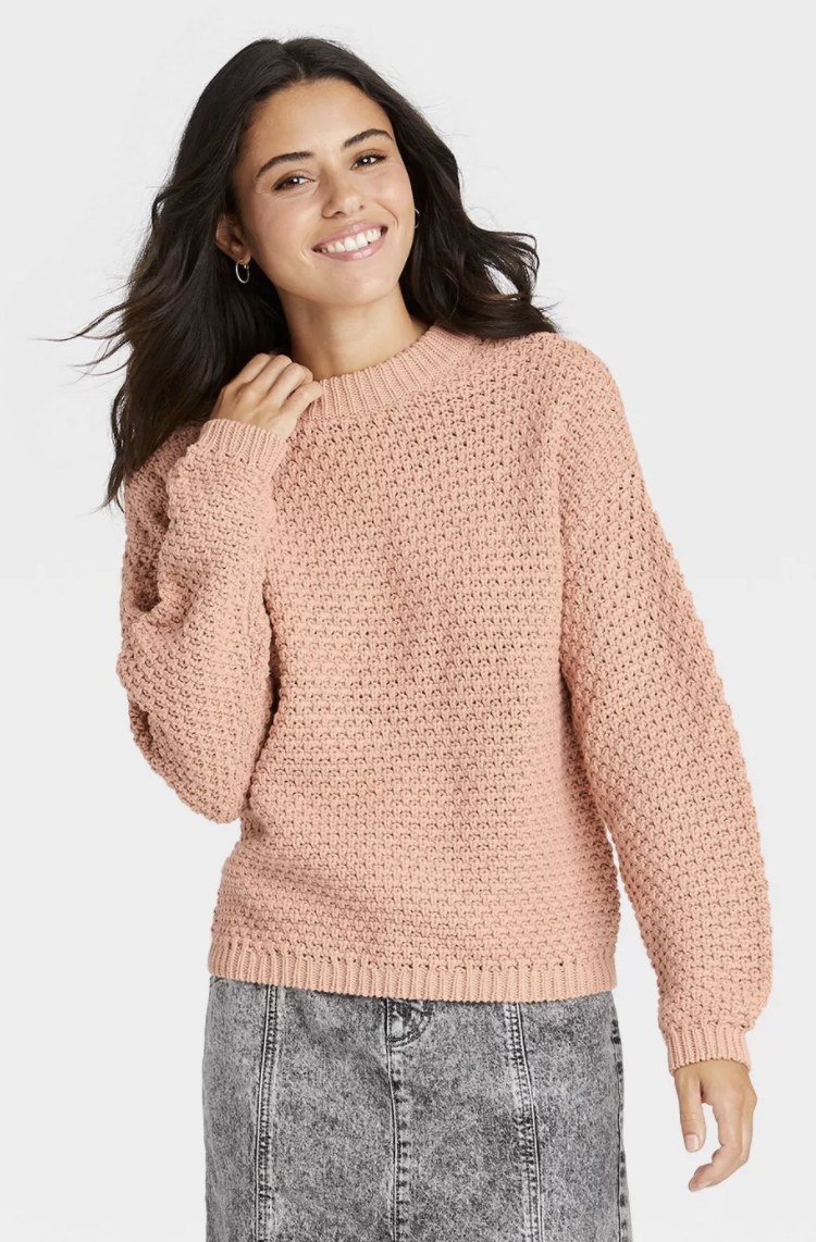 model wearing blush pink pullover sweater
