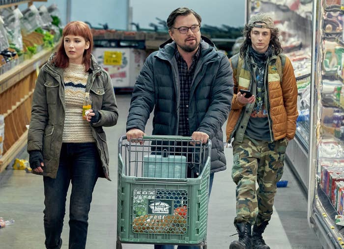 Timothée's character walks through a supermarket with Jennifer and Leonardo DiCaprio's charcters