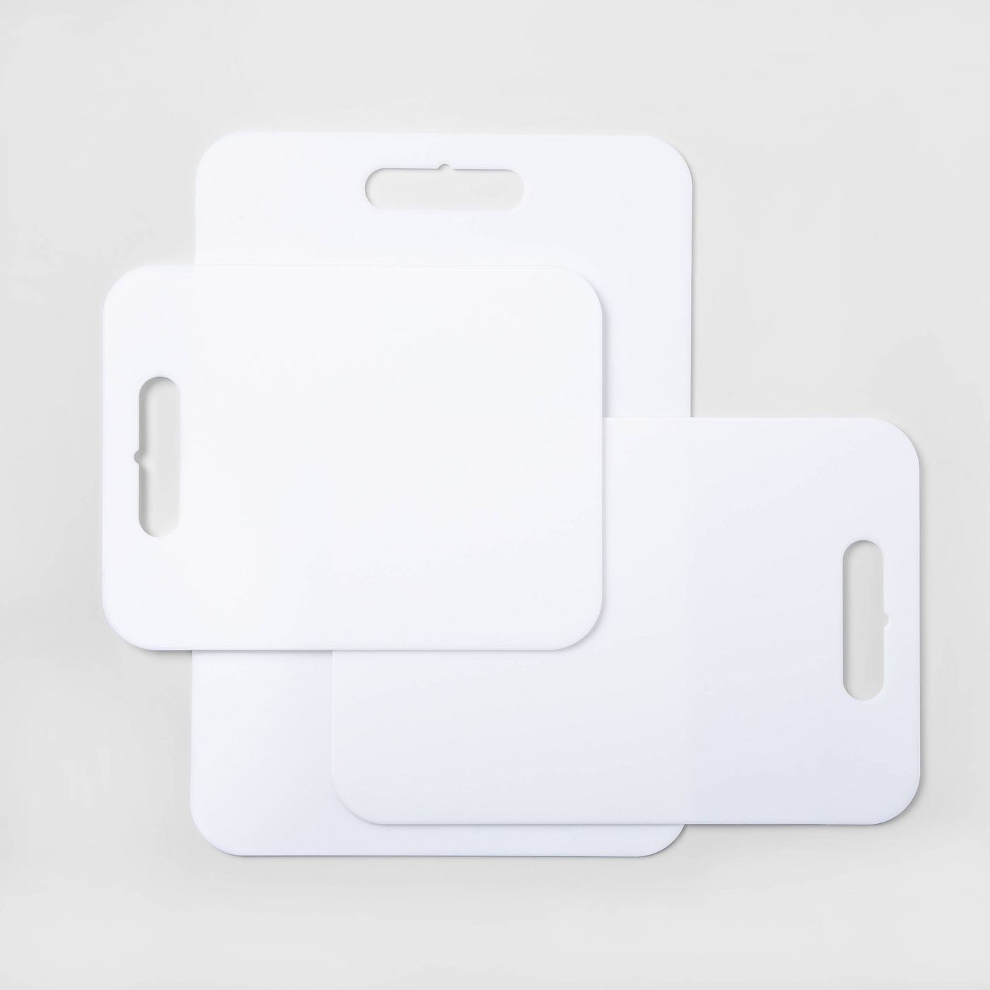 A set of three white cutting boards