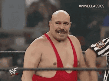 Iron Sheik lifting his arms in the air after a wrestling match