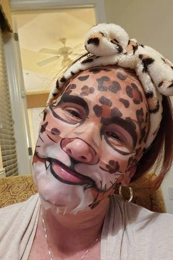 reviewer wearing leopard face sheet mask