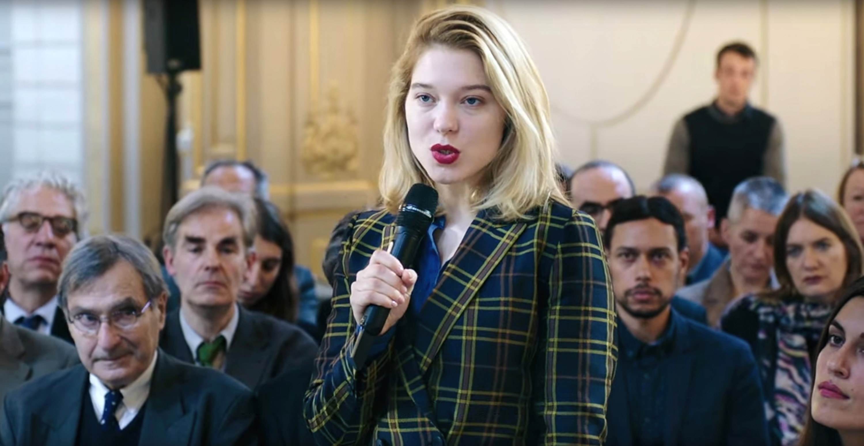 Lea Seydoux stands with a microphone
