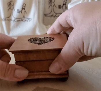 GIF of someone opening the music box to show the inner mechanism