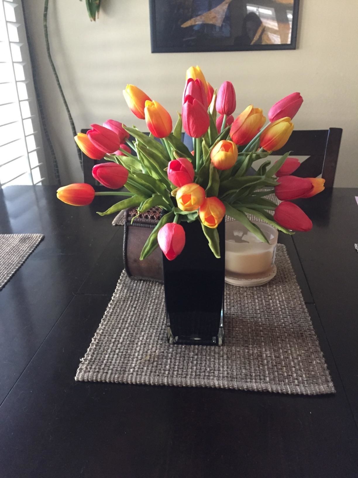 yellow and orange faux tulips in vase in a reviewer's home