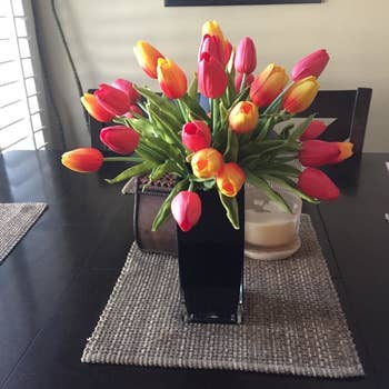 yellow and orange faux tulips in vase in a reviewer's home
