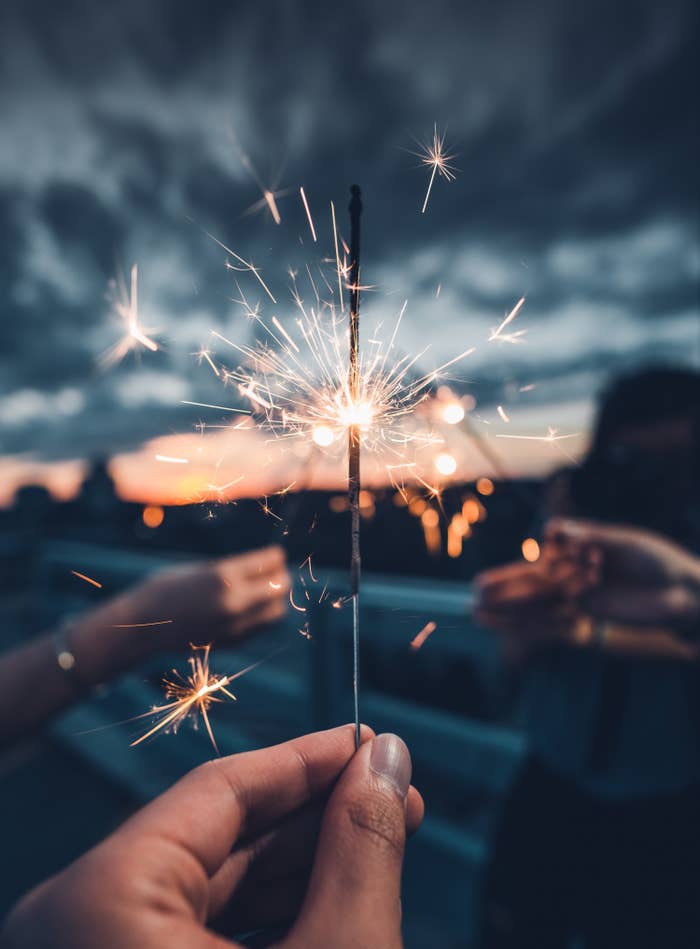 Hand holding a sparkler.