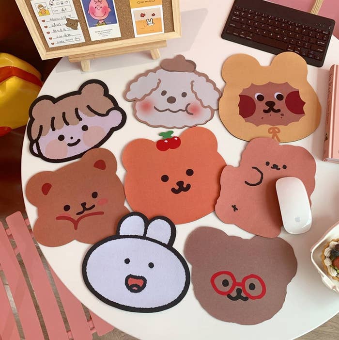 mousepads shaped like bears, faces, bunnies, and a dog with a hat