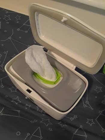 reviewer's photo showing how the Costco's Kirkland brand baby wipes fit perfectly in the dispenser