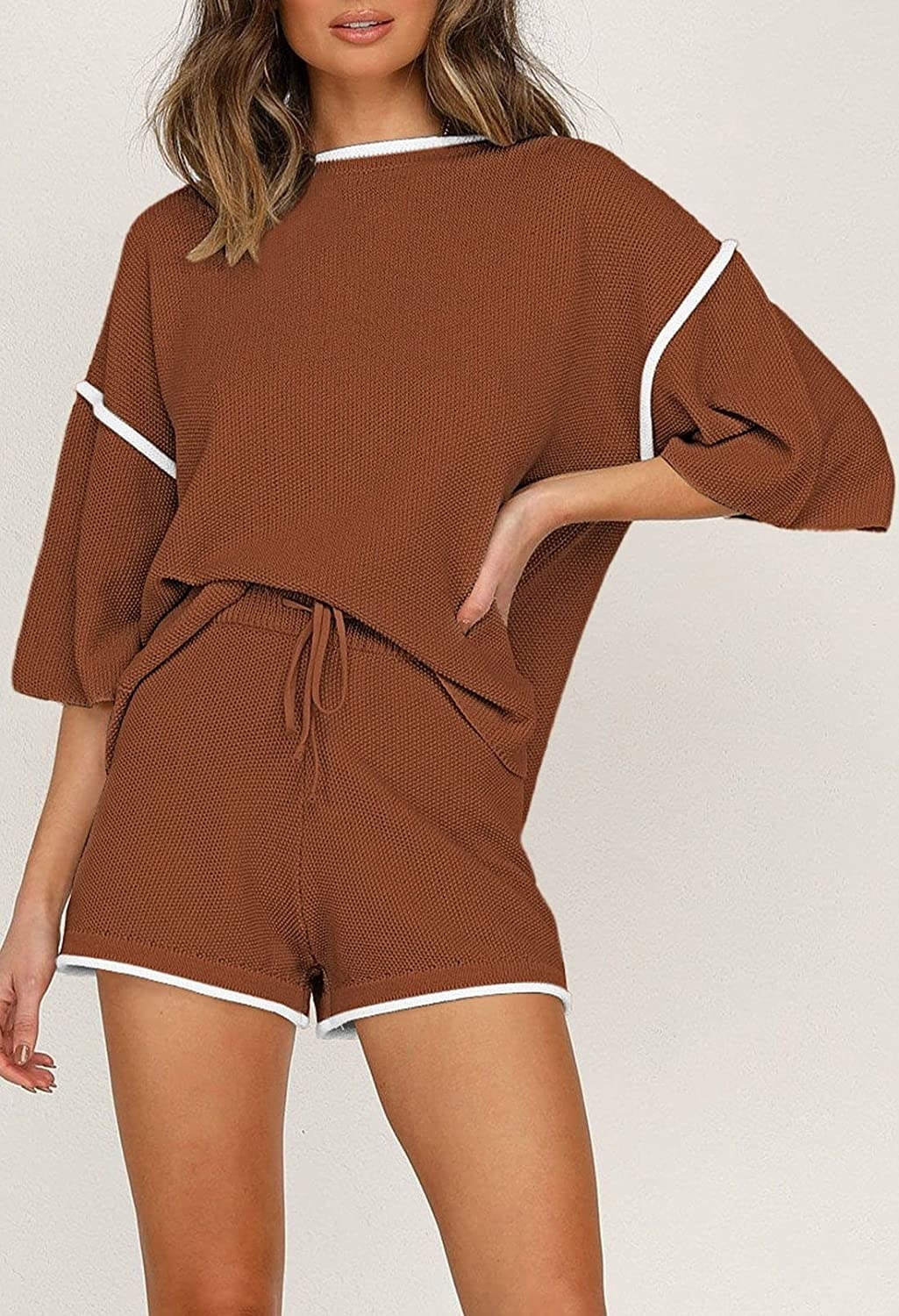 a model wearing the brown and white oversized knit shirt and matching shorts