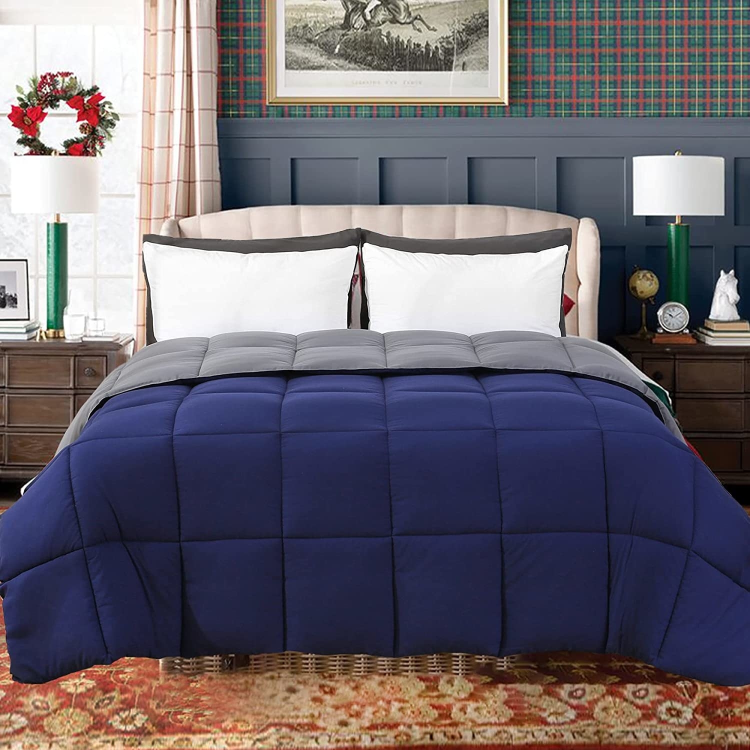 navy and gray reversible comforter on mattress in bedroom