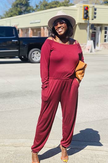 one reviewer photo wearing the jumpsuit in red with heels