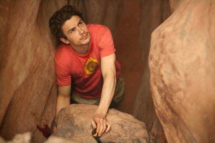 James Franco with his arm trapped in between two rocks