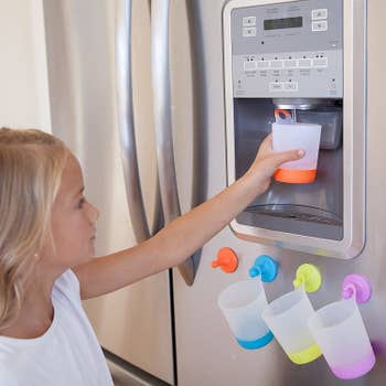 A model using the hanging cup to get water from the fridge