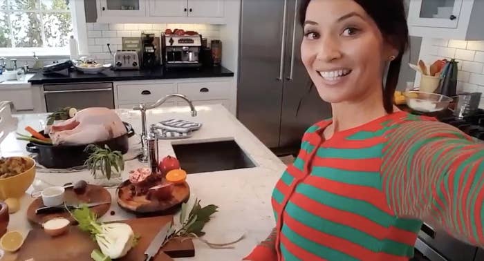 Olivia smiles while standing in a kitchen