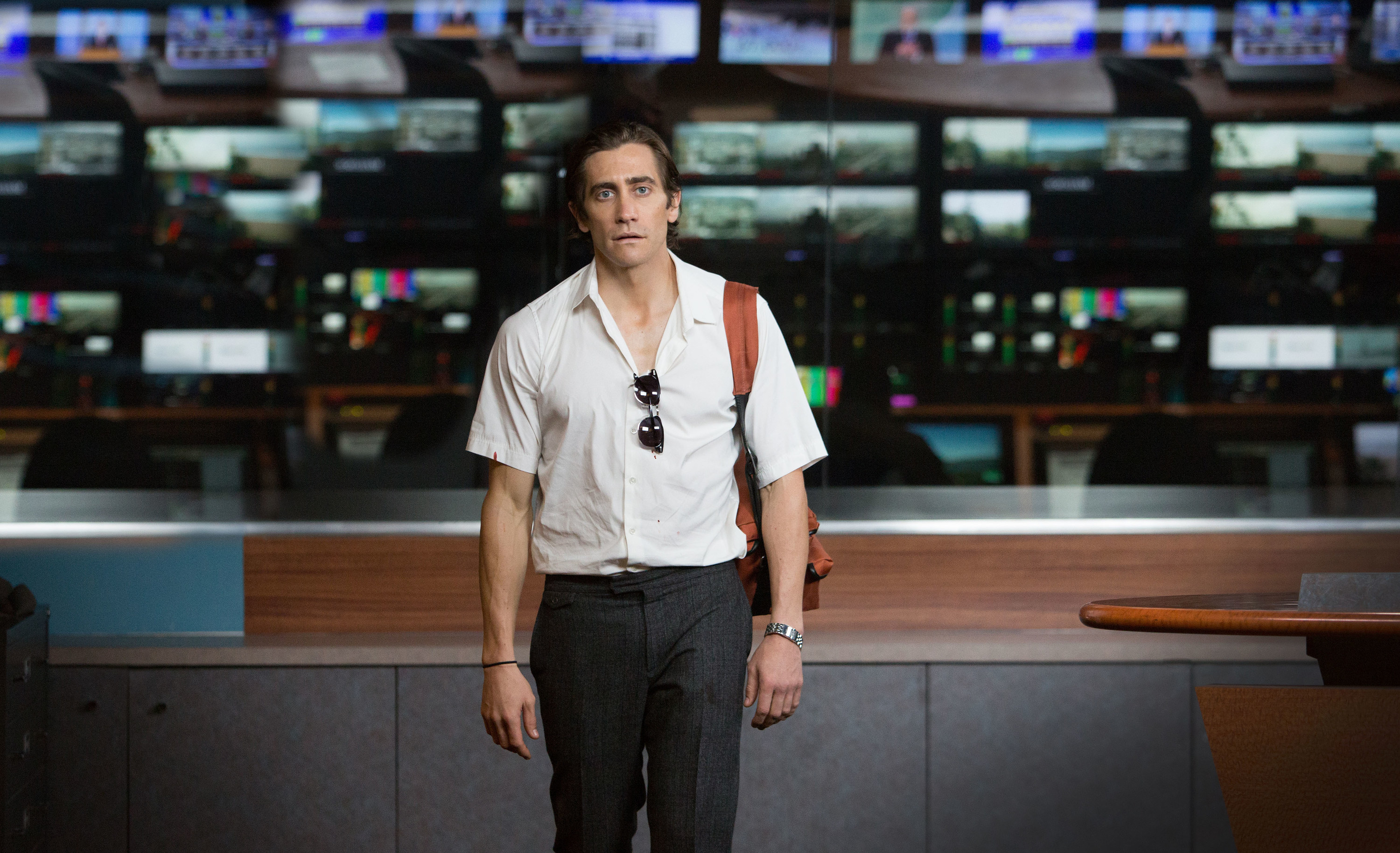 Jake Gyllenhaal stands in a news studio