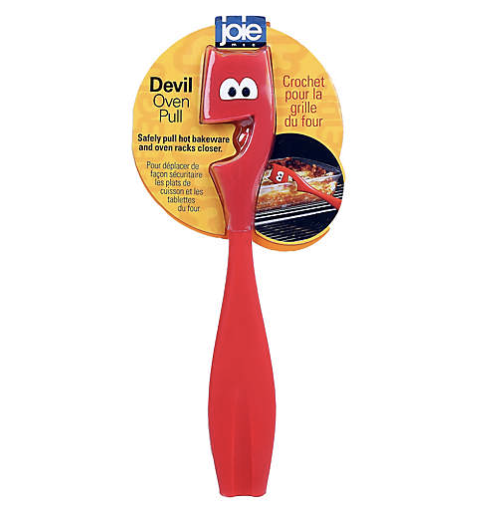 Red devil-shaped oven puller in yellow packaging