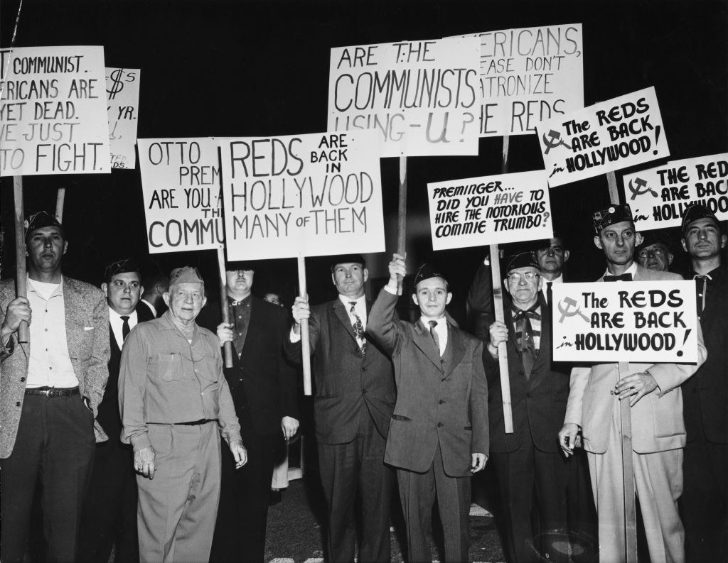 A group of protesters demonstrate holding placards against Communist sympathizers outside the Fox Wilshire Theatre in Los Angeles, California December 1960