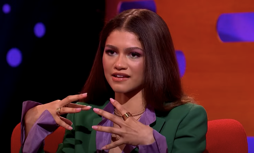 Zendaya lifting her hands to illustrate what the suit is like