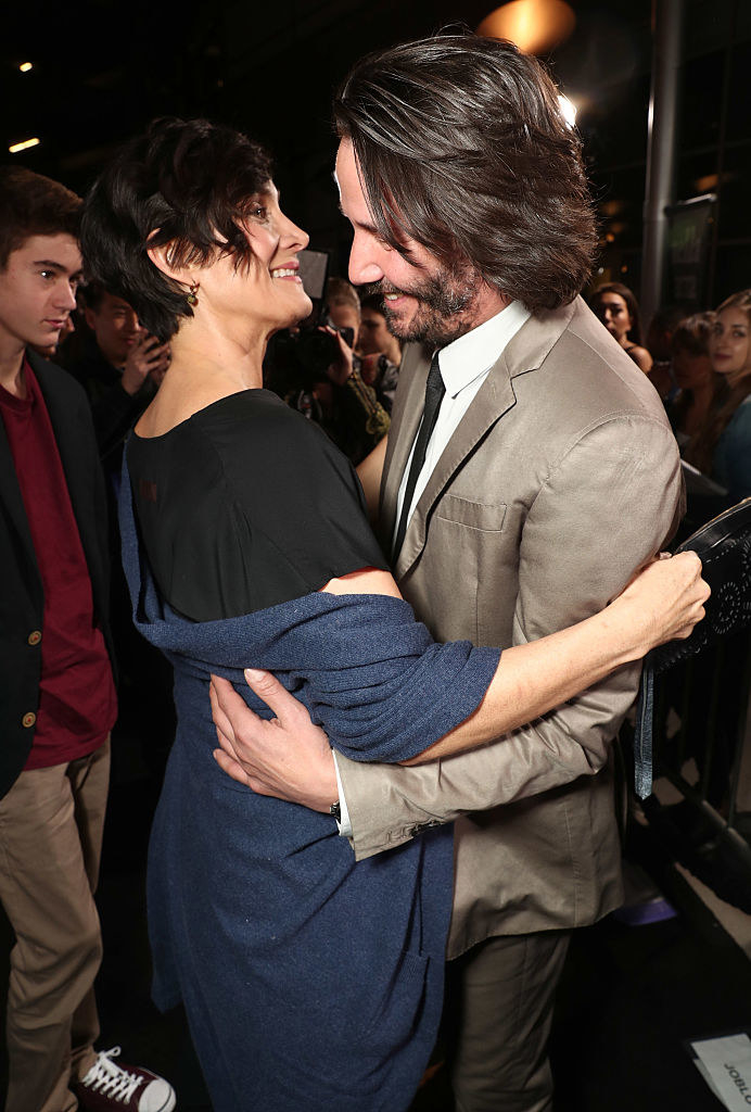 Carrie-Ann and Keanu embracing