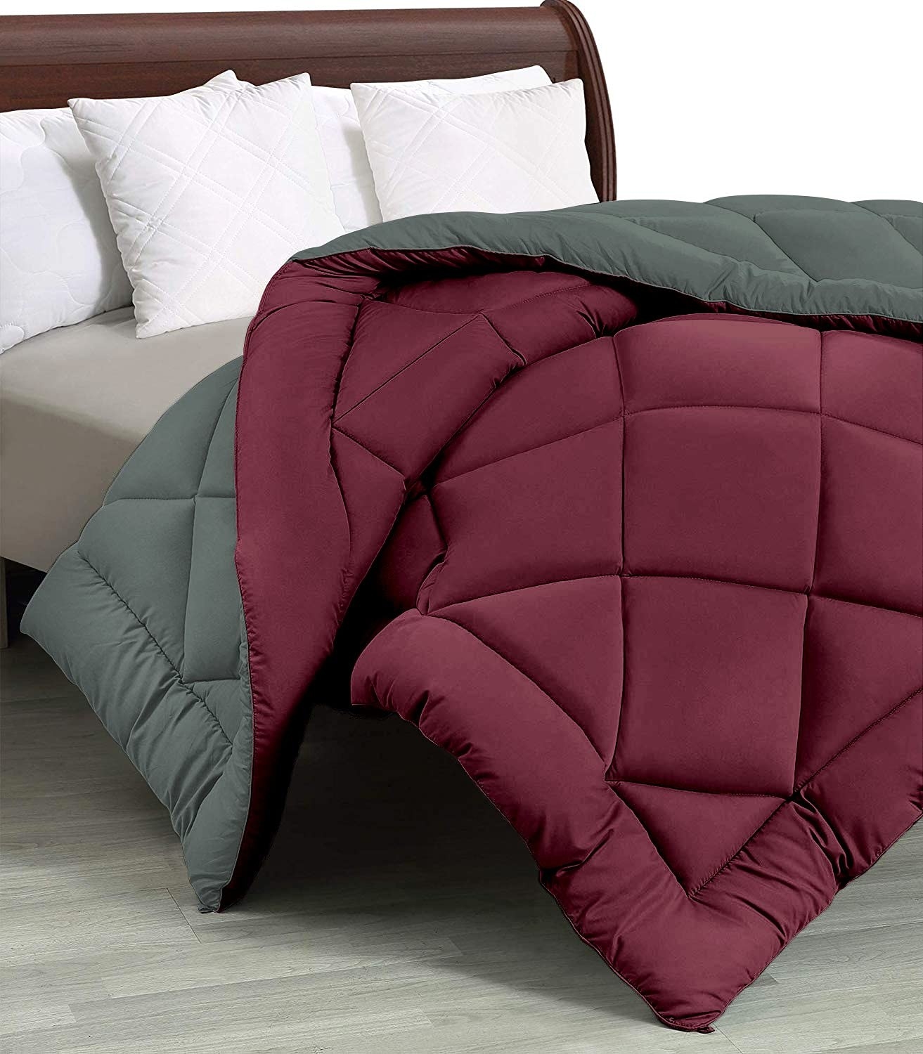 A red and grey comforter on a bed