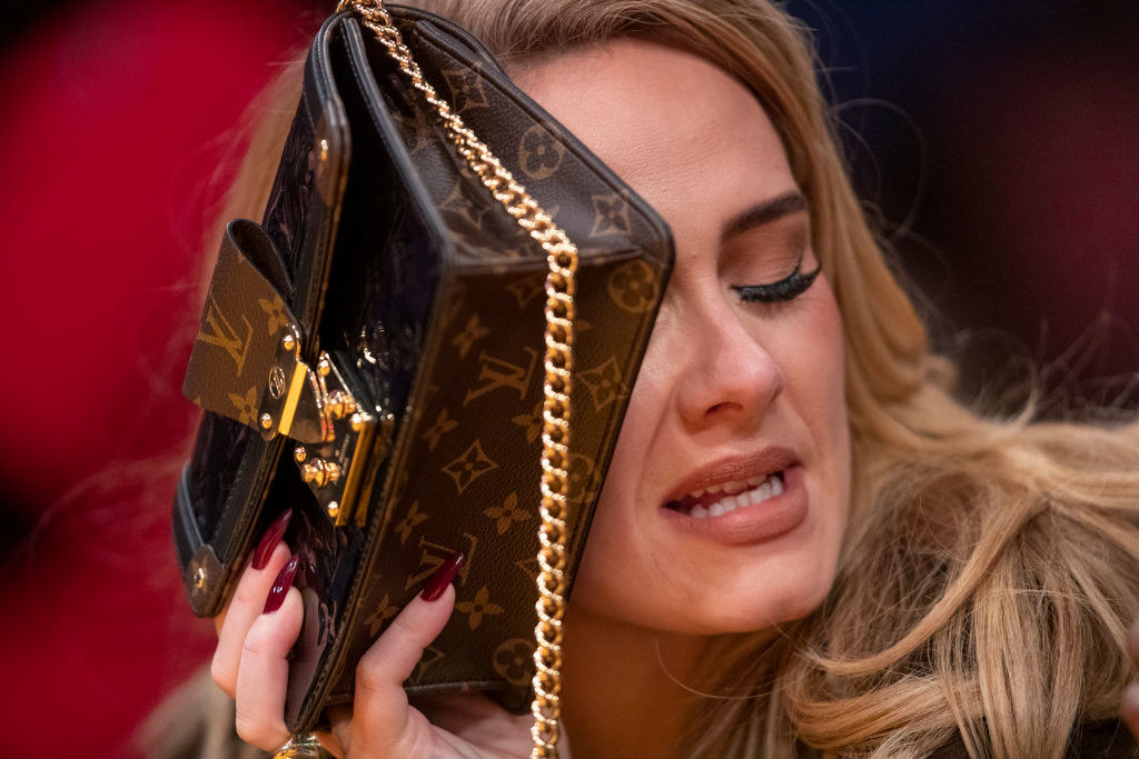 Adele hiding behind her Louis Vuitton purse